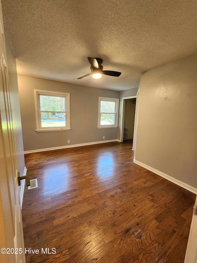 106 Hunters Trl E, Elizabeth City, NC 27909 - spare room with baseboards, dark wood-style flooring, visible vents, and a ceiling fan