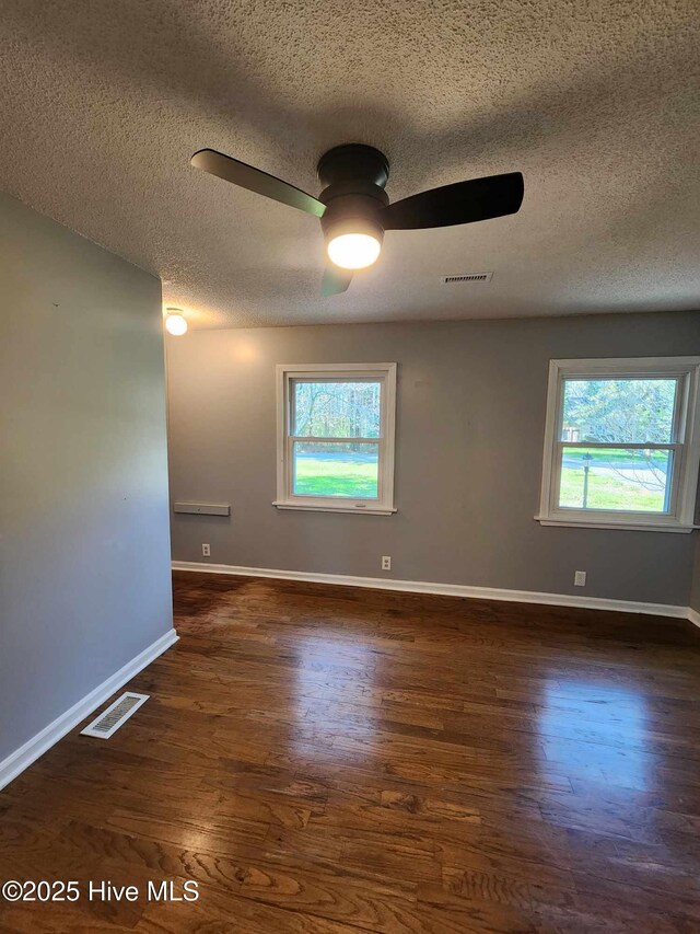 106 Hunters Trl E, Elizabeth City, NC 27909 - empty room featuring ceiling fan, visible vents, plenty of natural light, and wood finished floors
