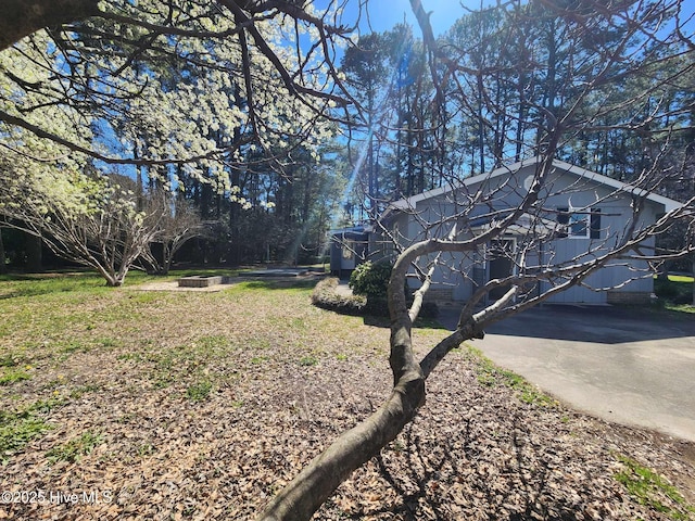 106 Hunters Trl E, Elizabeth City, NC 27909 - view of property exterior with a fire pit