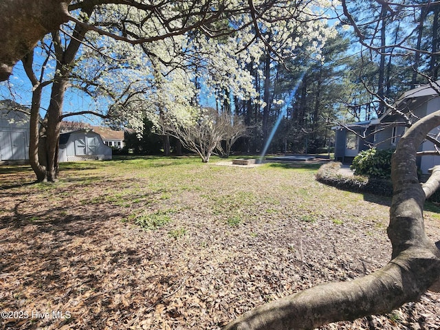 106 Hunters Trl E, Elizabeth City, NC 27909 - view of yard featuring an outbuilding and a shed