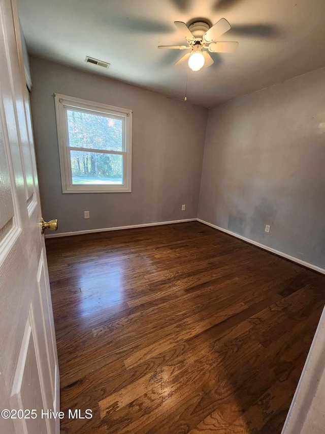 106 Hunters Trl E, Elizabeth City, NC 27909 - spare room with baseboards, visible vents, a ceiling fan, and dark wood-style flooring