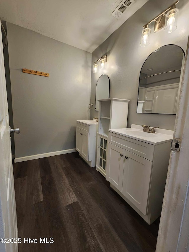 106 Hunters Trl E, Elizabeth City, NC 27909 - full bath with visible vents, baseboards, wood finished floors, two vanities, and a sink