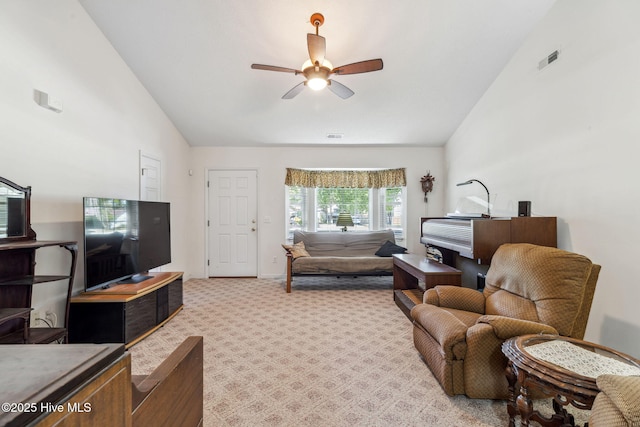living area featuring a ceiling fan, light colored carpet, visible vents, and high vaulted ceiling