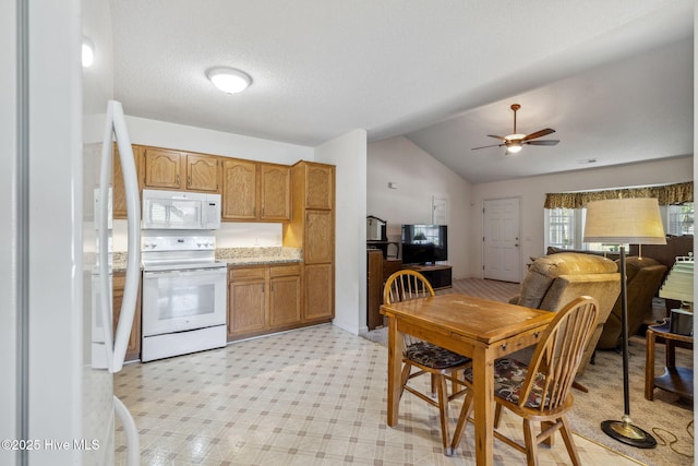 kitchen with white appliances, light floors, ceiling fan, light countertops, and vaulted ceiling