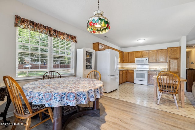 dining room featuring a healthy amount of sunlight and light floors