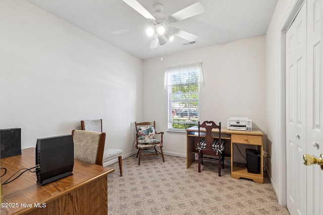 office featuring baseboards, a ceiling fan, light colored carpet, and visible vents