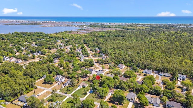 bird's eye view with a water view, a residential view, and a wooded view