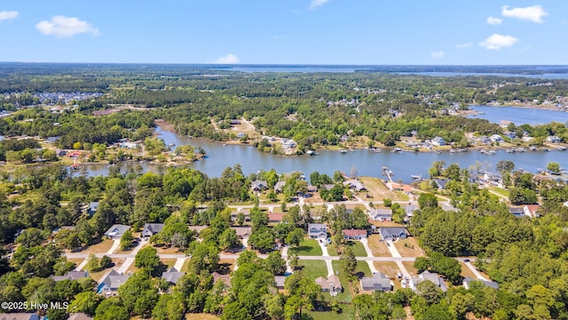 aerial view with a water view, a view of trees, and a residential view