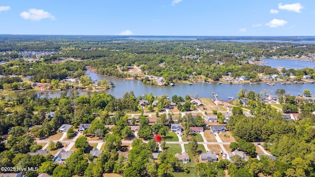 bird's eye view with a water view, a residential view, and a wooded view