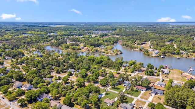 drone / aerial view featuring a water view, a view of trees, and a residential view