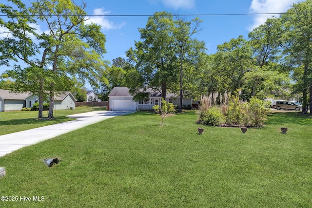 obstructed view of property featuring a garage, driveway, and a front yard