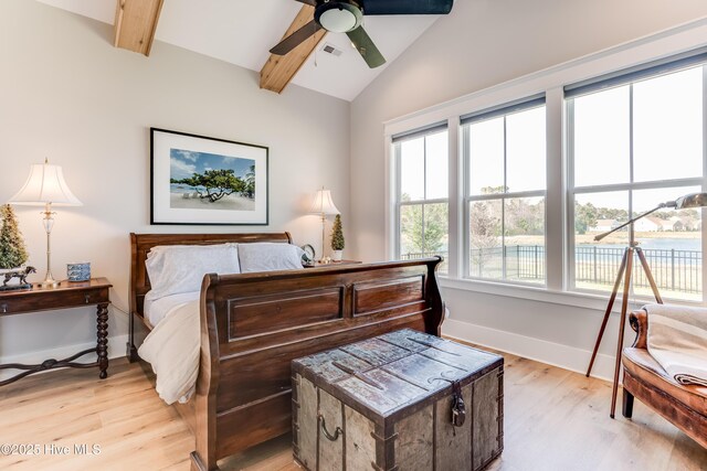 266 Twining Rose Ln, Holly Ridge, NC 28445 - bedroom with light wood-style floors, baseboards, multiple windows, and beam ceiling