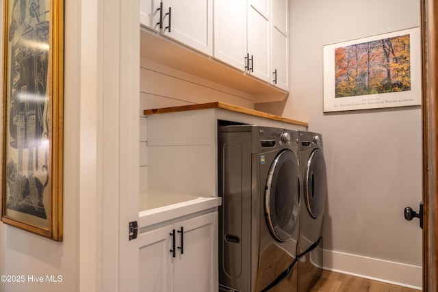 266 Twining Rose Ln, Holly Ridge, NC 28445 - clothes washing area with cabinet space, baseboards, washer and clothes dryer, and wood finished floors