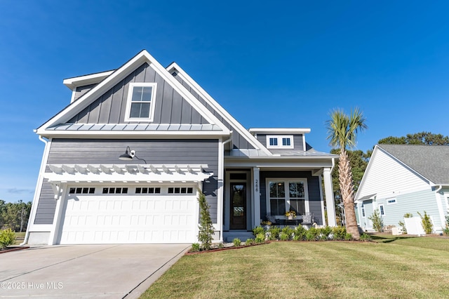 266 Twining Rose Ln, Holly Ridge, NC 28445 - craftsman-style house with a porch, board and batten siding, a standing seam roof, a front lawn, and concrete driveway