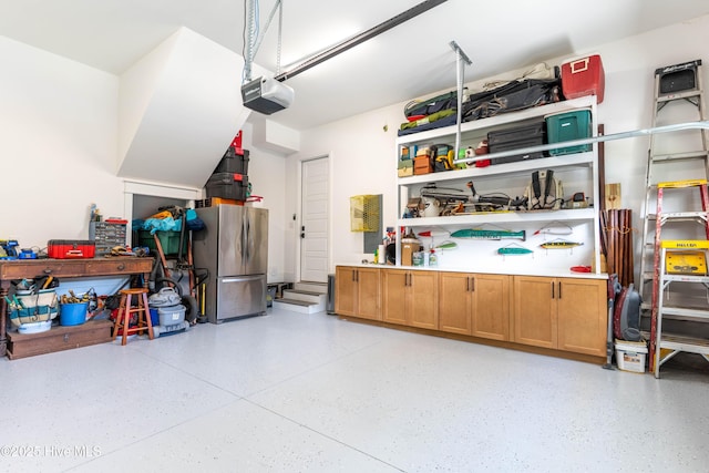 266 Twining Rose Ln, Holly Ridge, NC 28445 - garage with a garage door opener and freestanding refrigerator