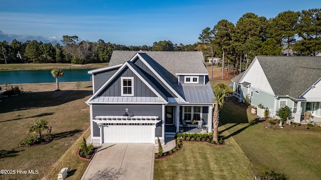 266 Twining Rose Ln, Holly Ridge, NC 28445 - view of front of house featuring board and batten siding, a front lawn, concrete driveway, a water view, and an attached garage