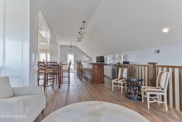 266 Twining Rose Ln, Holly Ridge, NC 28445 - living area featuring bar, vaulted ceiling, ornate columns, and wood finished floors