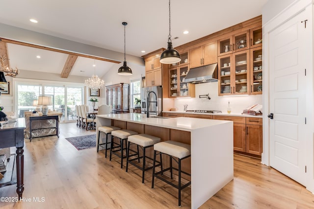 266 Twining Rose Ln, Holly Ridge, NC 28445 - kitchen with an inviting chandelier, a sink, light countertops, light wood-style flooring, and under cabinet range hood