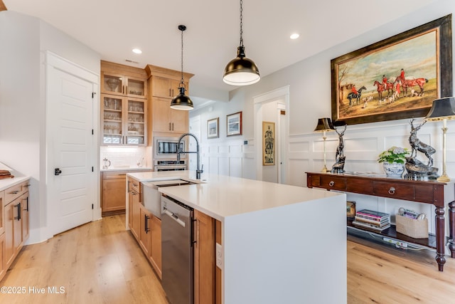 266 Twining Rose Ln, Holly Ridge, NC 28445 - kitchen featuring light countertops, appliances with stainless steel finishes, a sink, and light wood-style floors