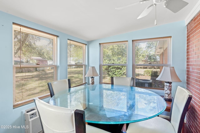 dining space featuring a ceiling fan and vaulted ceiling