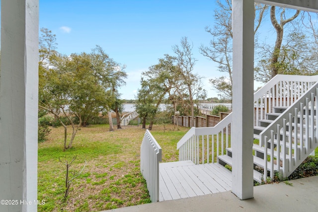view of yard with fence, stairs, and a wooden deck