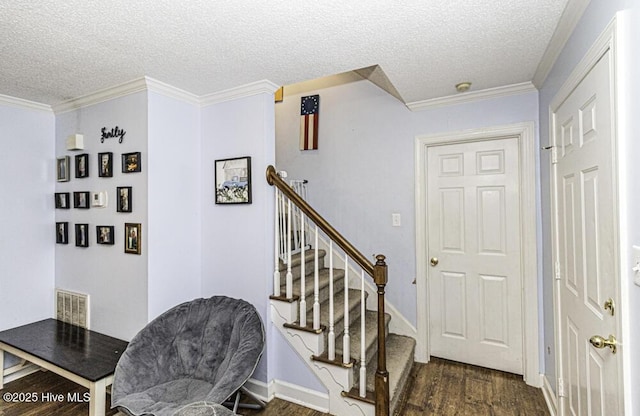 200 Emerson Dr, Rocky Mount, NC 27803 - staircase featuring visible vents, ornamental molding, a textured ceiling, and wood finished floors