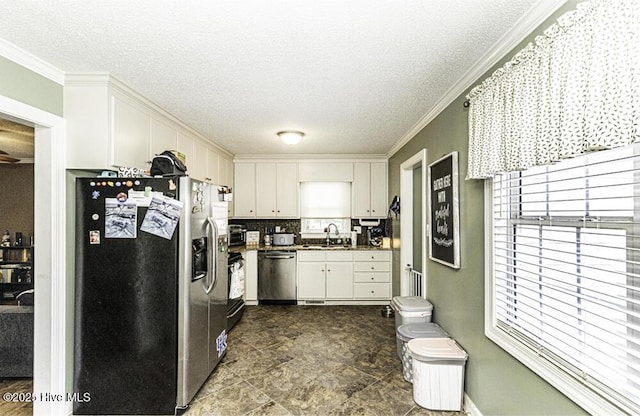 200 Emerson Dr, Rocky Mount, NC 27803 - kitchen featuring white cabinetry, ornamental molding, a sink, and stainless steel appliances