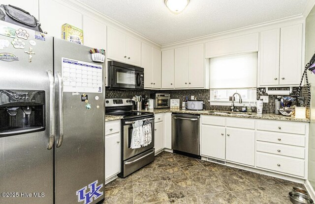 200 Emerson Dr, Rocky Mount, NC 27803 - kitchen with decorative backsplash, stainless steel appliances, white cabinetry, a sink, and light stone counters