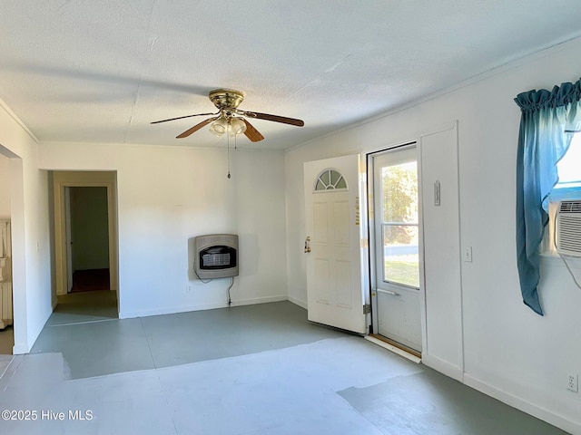 entryway with concrete floors, baseboards, ceiling fan, heating unit, and a textured ceiling