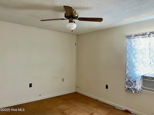unfurnished room with baseboards, a textured ceiling, and a ceiling fan