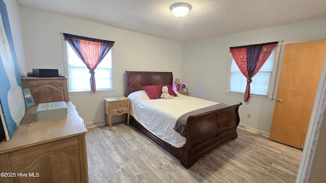 304 Mary Ave, Castle Hayne, NC 28429 - bedroom featuring light wood-type flooring, a textured ceiling, and baseboards