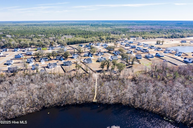 birds eye view of property featuring a residential view, a water view, and a view of trees