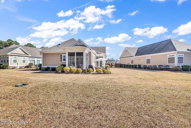 9353 Honey Tree Ln NW, Calabash, NC 28467 - rear view of property with a sunroom and a lawn