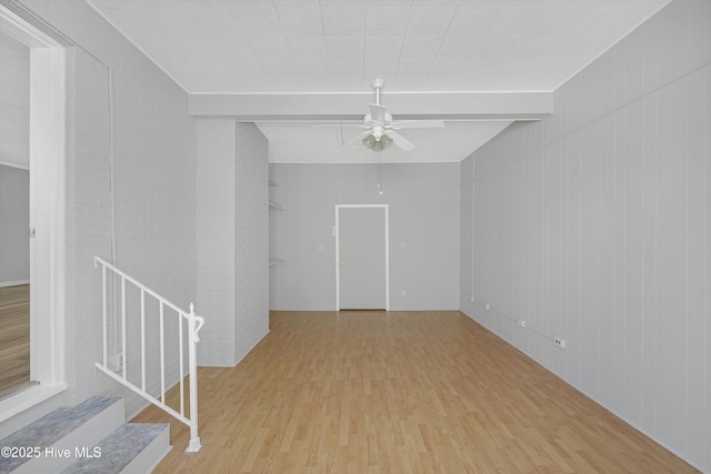 302 NE 60th St, Oak Island, NC 28465 - unfurnished room featuring wood finished floors, a ceiling fan, beamed ceiling, and stairs