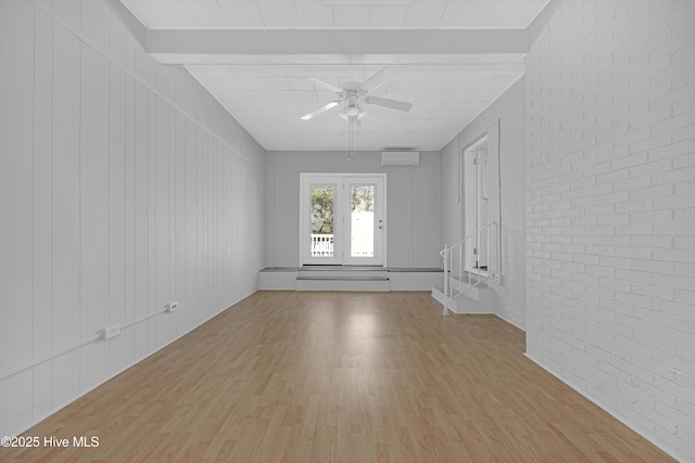 302 NE 60th St, Oak Island, NC 28465 - unfurnished room with light wood-style floors, ceiling fan, brick wall, and an AC wall unit
