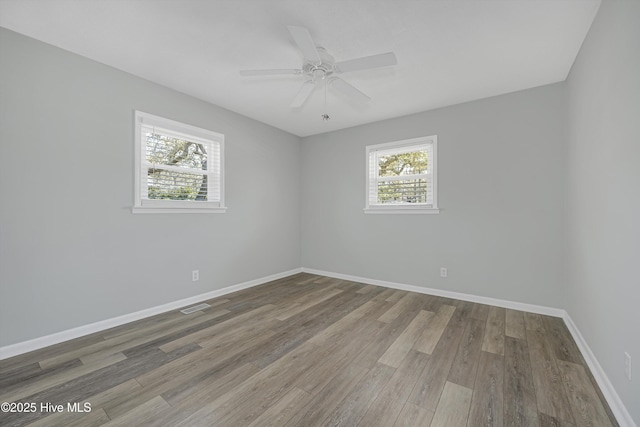 302 NE 60th St, Oak Island, NC 28465 - empty room with wood finished floors, baseboards, and a ceiling fan