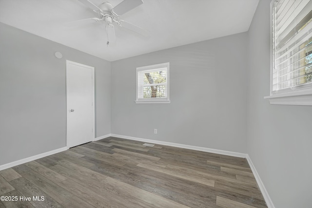 302 NE 60th St, Oak Island, NC 28465 - empty room featuring baseboards, a ceiling fan, and wood finished floors