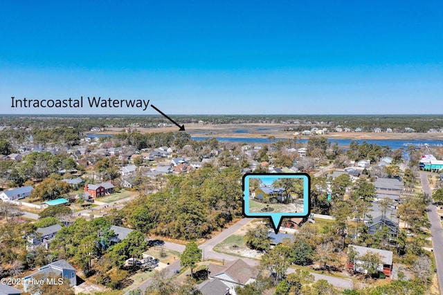 302 NE 60th St, Oak Island, NC 28465 - aerial view of property and surrounding area with nearby suburban area, a large body of water, and property parcel outlined