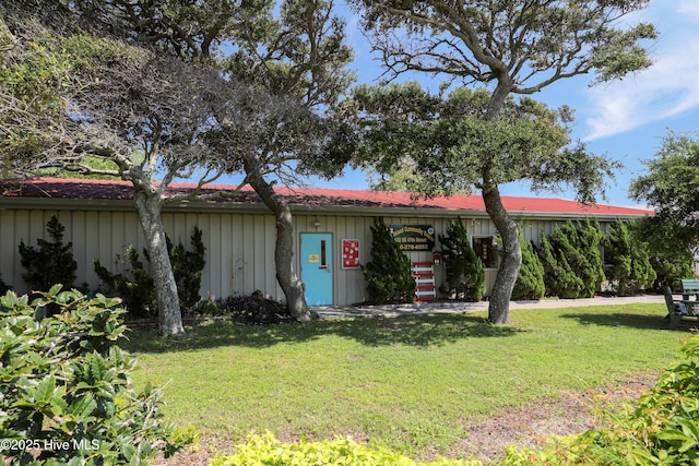 302 NE 60th St, Oak Island, NC 28465 - view of front of property with a front yard and board and batten siding