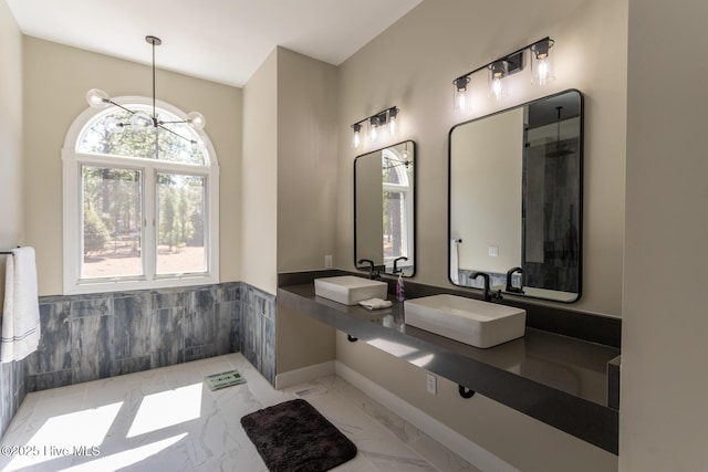 86 Sakonnet Trl, Pinehurst, NC 28374 - full bath featuring a sink, marble finish floors, a wainscoted wall, and baseboards