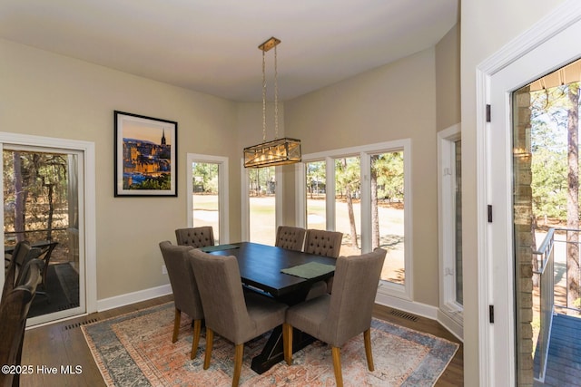 86 Sakonnet Trl, Pinehurst, NC 28374 - dining area with plenty of natural light, baseboards, wood finished floors, and a chandelier