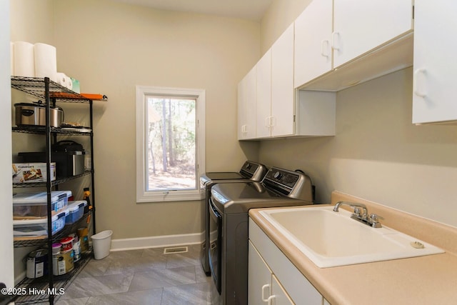 86 Sakonnet Trl, Pinehurst, NC 28374 - clothes washing area featuring cabinet space, washer and clothes dryer, and baseboards