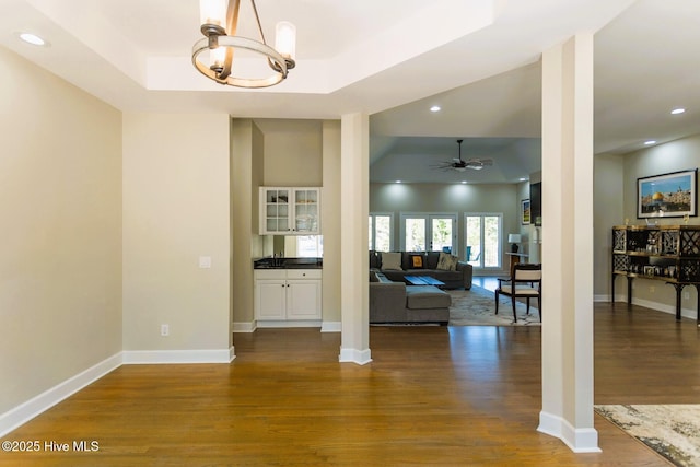 86 Sakonnet Trl, Pinehurst, NC 28374 - living area featuring a tray ceiling, dark wood-type flooring, a chandelier, ceiling fan, and recessed lighting