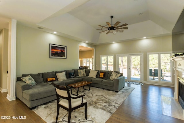 86 Sakonnet Trl, Pinehurst, NC 28374 - living room featuring wood finished floors, a glass covered fireplace, ceiling fan, a tray ceiling, and recessed lighting