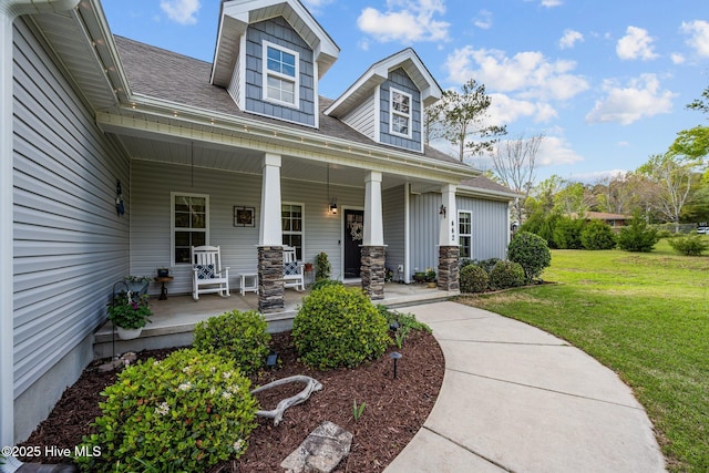 442 Crows Nest Ln, Sneads Ferry, NC 28460 - view of front of home with covered porch, a front lawn, and roof with shingles