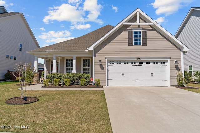 craftsman inspired home with covered porch, concrete driveway, and a front yard