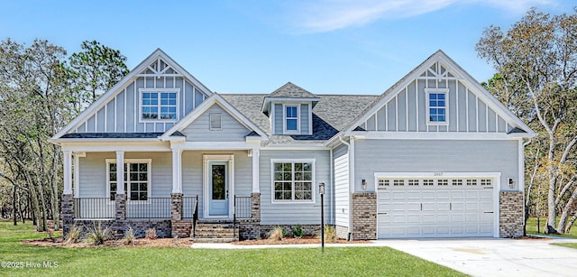 2967 Lake Pointe Dr SW, Supply, NC 28462 - craftsman house featuring roof with shingles, driveway, a porch, board and batten siding, and a front yard