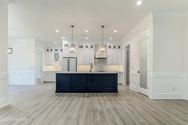 2967 Lake Pointe Dr SW, Supply, NC 28462 - kitchen with high end fridge, light wood-type flooring, a decorative wall, and custom range hood