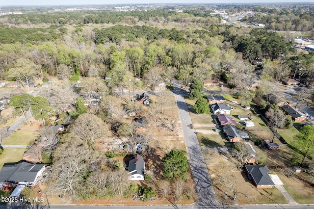drone / aerial view with a wooded view