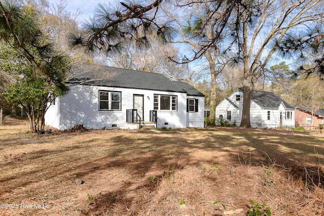 view of front of house with roof with shingles and crawl space